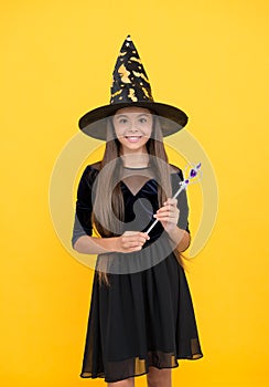 Magic lesson. happy childhood. teenage child in witch hat. cheerful kid create miracles with magic wand. carnival