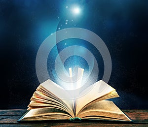 Magic light emanating from open old book