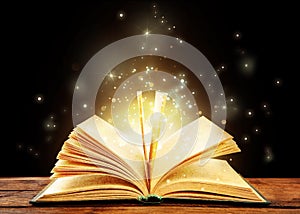 Magic light emanating from open book on table