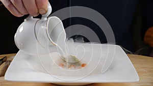 Magic Liquid nitrogen. Foodart. Chef cooking Tartare. Restaurant Tasty food concept. Final touch in dish serving. Slow