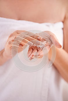 The magic lotion. Cropped studio shot of a mature woman applying moisturizer.