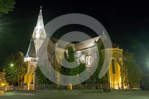 Magic medieval church near green park at night