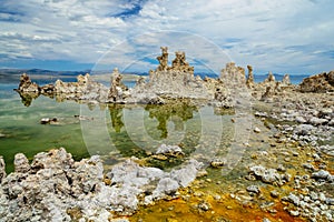 Magic of Mono Lake. Outliers - bizarre calcareous tufa formation on the smooth water of the lake.