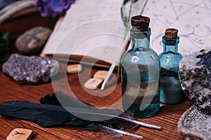 Witchcraft concept with potions, herbs and occult equipment photo