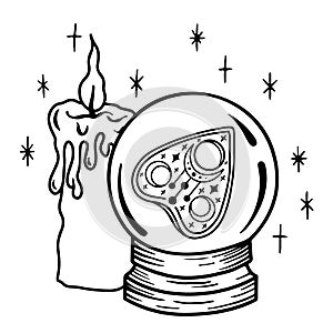 A magic prediction ball with a Ouija Board pointer inside and a candle. Magic crystal ball for divination