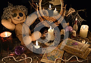 Magic ritual with voodoo doll, mirror and tarot cards