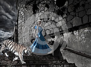 Magic scene- fantastic princess from fairy tale with a tiger on old tower steps