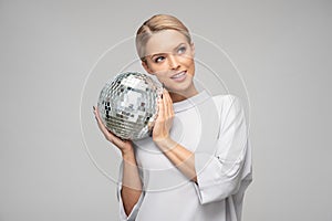 magic shimmering young woman holding a disco ball
