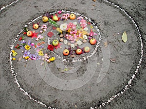 Magic spiral works next to a lake, wicca altar. Pagan religion.