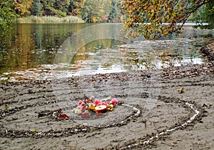 Magic spiral works next to a lake, wicca altar. Pagan religion.