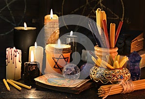Magic still life with candles, books and the tarot cards