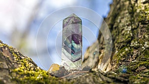 Magic still life with Gemstones fluorite crystal on nature background. Rocks for mystic ritual, witchcraft Wiccan or spiritual