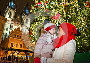 Mother and child in Christmas Prague looking at each other photo