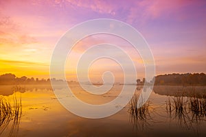 Magic sunrise over the lake. Misty early morning