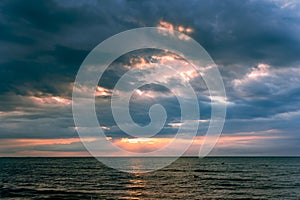 Magic sunset with dark storm clouds above the Baltic sea in Jurmala