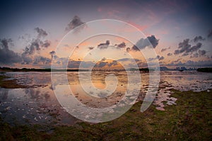 Magic sunset in river and mudland