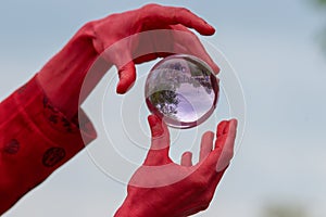 Magic trick balancing glass cystal ball in the air between hands