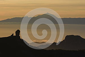 Magic view of Roque Nublo and the magestic Teide peak on the island of Tenerife in the background at sunset
