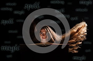 Magic Woman reading a book. Witch cast a spell. Black background