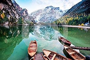 Magical autumn landscape with boats on the lake on Fanes-Sennes-Braies natural park in the Dolomites in South Tyrol, Alps, Italy