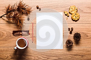 Magical christmas theme background, pine cones, coffee, cookies and an empty letter to santa