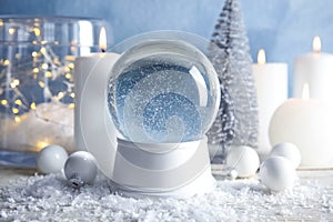 Magical empty snow globe with Christmas decorations and candles