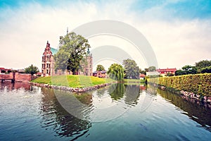 Magical fascinating landscape with famous Rosenborg Castle near pond in palace garden in Copenhagen, Denmark. Exotic amazing