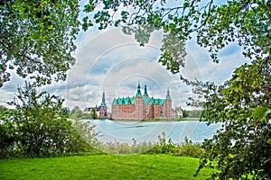 Magical fascinating landscape landscape with lake and largest renaissance castle in Scandinavia Frederiksborg slot Castle near