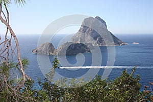 The magical island of Es Vedra with the small islet of Es Vedranell next to it in front of the coast of Cala d`Hort in the touris