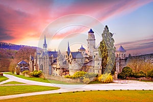 Magical landscape with medieval Lion castle or Lowenburg in Wilhelmshoehe Castle Park in Kassel, Germany, Europe at dawn.