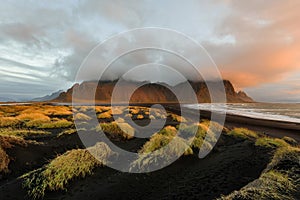 Magical landscape of Vestrahorn Mountains and Black sand dunes in Iceland at sunrise.  Panoramic view of the Stokksnes headland in