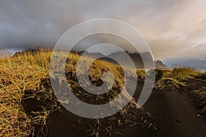 Magical landscape of Vestrahorn Mountains and Black sand dunes in Iceland at sunrise. Panoramic view of the Stokksnes headland in