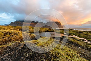 Magical landscape of Vestrahorn Mountains and Black sand dunes in Iceland at sunrise.  Panoramic view of the Stokksnes headland in