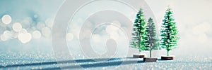 Magical miniature winter wonderland banner. Evergreen christmas trees on shiny blue background.