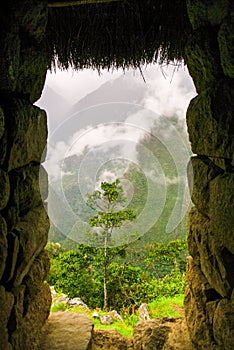 The magical mountain of Machu Pichu, in Peru, with twists and turns of clouds between its peaks