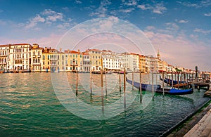 Magical panoramic view during sunset over gondolas in Venice, Grand Canal and its historical center, Venice, Italy, summer time,