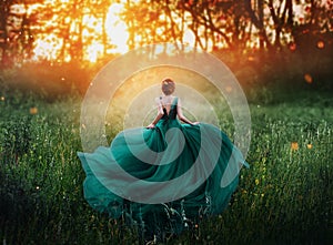 Magical picture, girl with red hair runs into dark mysterious forest, lady in long elegant royal expensive emerald green photo