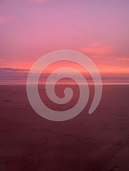 Magical pink sunset over the enchanted beach in a vertical view