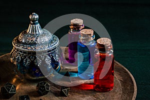 Magical potions and a glass pot with RPG dice photo