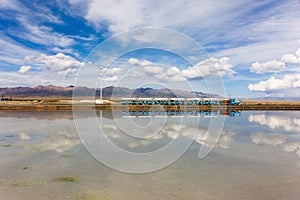 Magical sky, strange clouds on the blue sky, reflection, small train, salt lake, afternoon view of Chaka Salt Lake in Qinghai, Chi