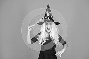 Magical spell. Little child in witch costume. Halloween party. Small girl in black witch hat. Autumn holiday. Join