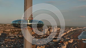 Magical sunset 4k aerial video of British Airways i360 viewing tower pod with tourists in Brighton