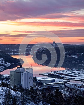 Magical sunset over the Halden town reflecting the pink sky on the quiet canal