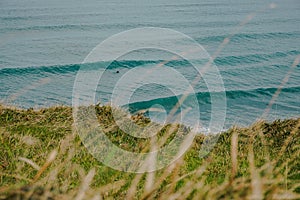 Magical view of the Atlantic Ocean with Waves and some Surfers.