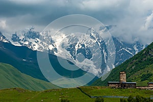 Magical view of the Caucasus Mountains, Georgia`s highest summit Shkhara and Lamaria Monastery, Ushguli, Georgia, Caucasus,