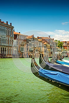 Magical view during sunset over gondolas in Venice, Grand Canal and its historical center, Venice, Italy, summer time, blue sky