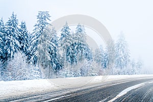 Magical winter landscape: road and snow covered trees