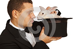 Magician face to face with a rabbit in a top hat