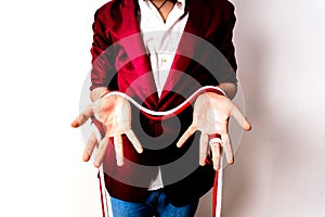 Magician hands handling ropes and bandanas to do magic tricks, isolated on white