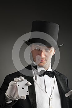 Magician holding playing cards